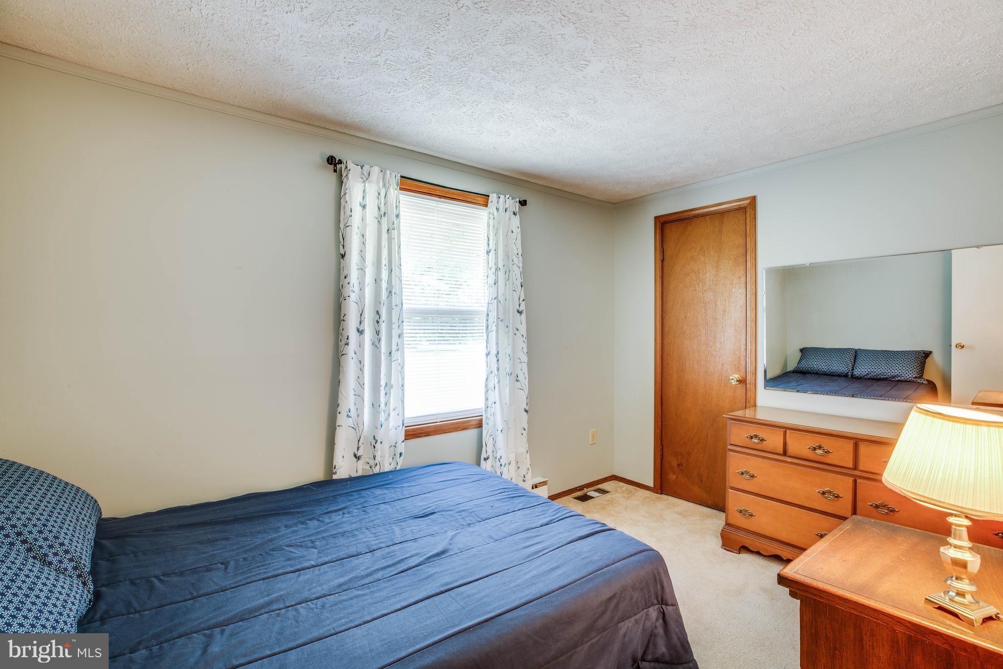 4314 Shepherds Road Partlow, VA 22534 - Photo 14 of 30 a bedroom with a bed and wooden floor