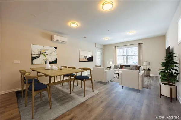 a view of a dining room with furniture and wooden floor