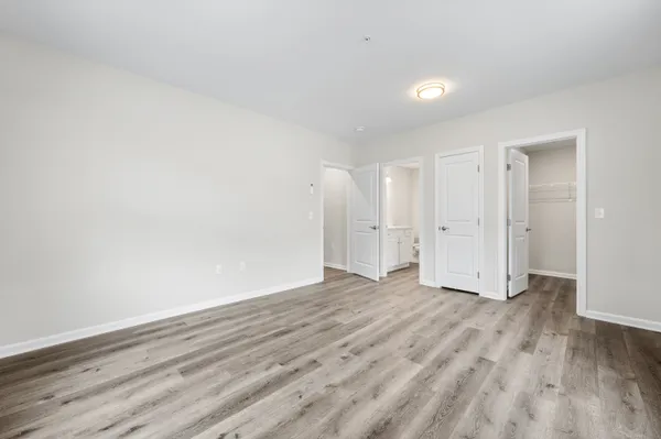 a view of an empty room and wooden floor