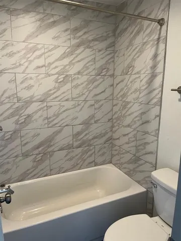 a view of patio with a table and chairs under an umbrella