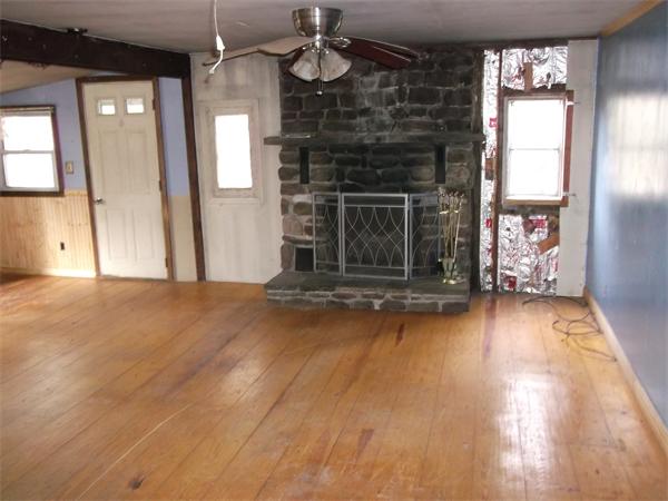 1 Hidden Acres Road Wales, MA 01081 - Photo 3 of 6 a view of a livingroom with wooden floor a fireplace and window