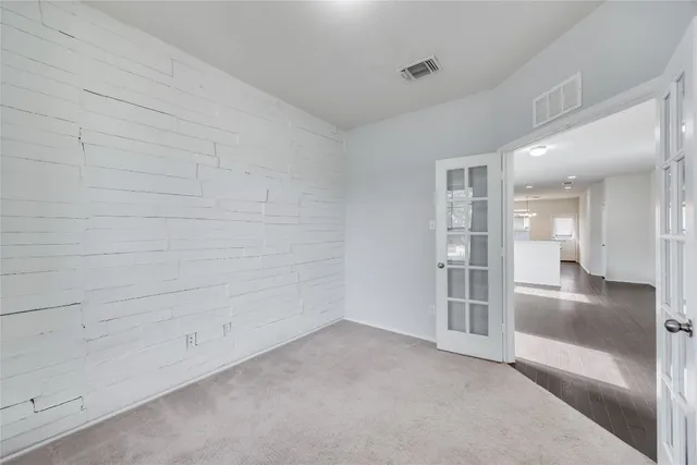 an empty room with windows and entrance