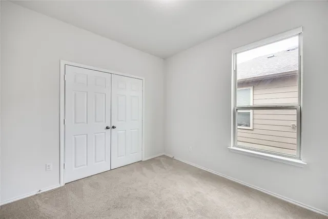 a view of an empty room and a window