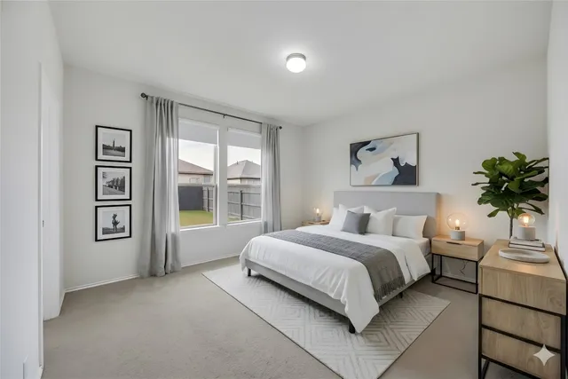 a bedroom with a large bed and a potted plant