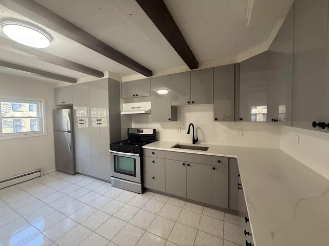 a kitchen with a sink cabinets and stainless steel appliances