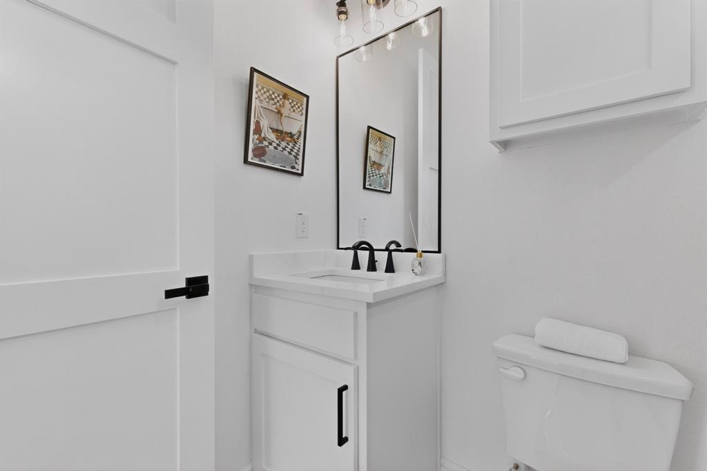 9080 County Road 669 Blue Ridge, TX 75424 - Photo 15 of 40 a bathroom with a toilet a sink and mirror