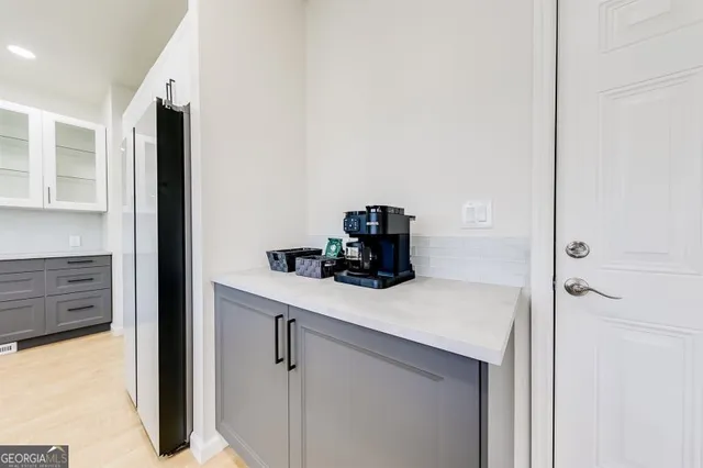 a kitchen with a refrigerator and cabinets