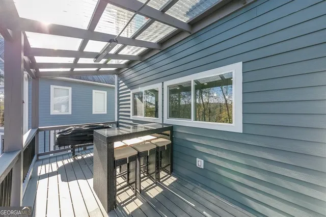 a view of a house with backyard and sitting area