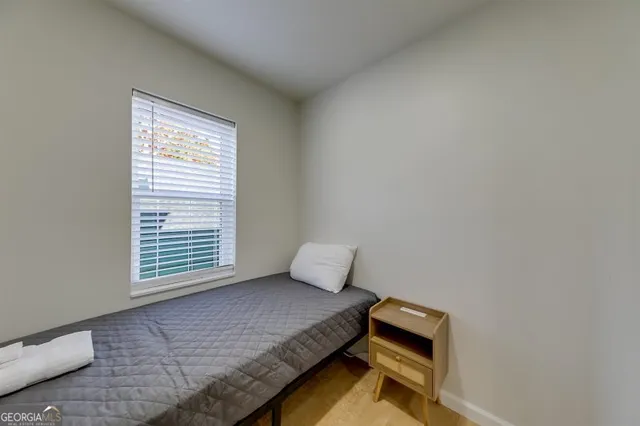 a bedroom with a bed and window