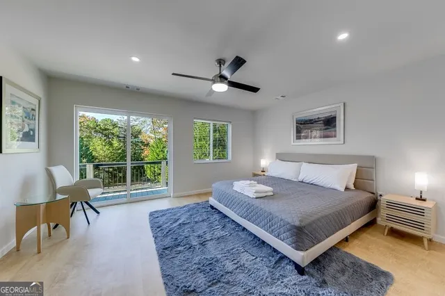 a bedroom with a large bed and a chandelier