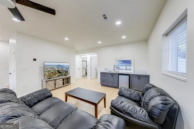 a living room with furniture and a large window