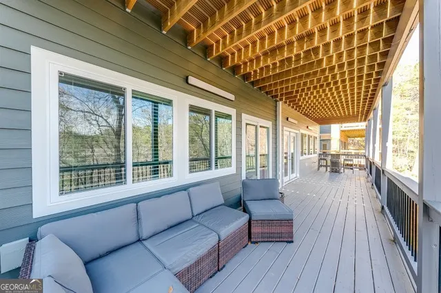 a balcony with wooden floor and outdoor seating