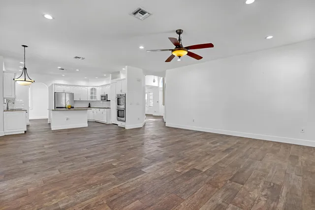 a view of a kitchen with a sink and wooden floor