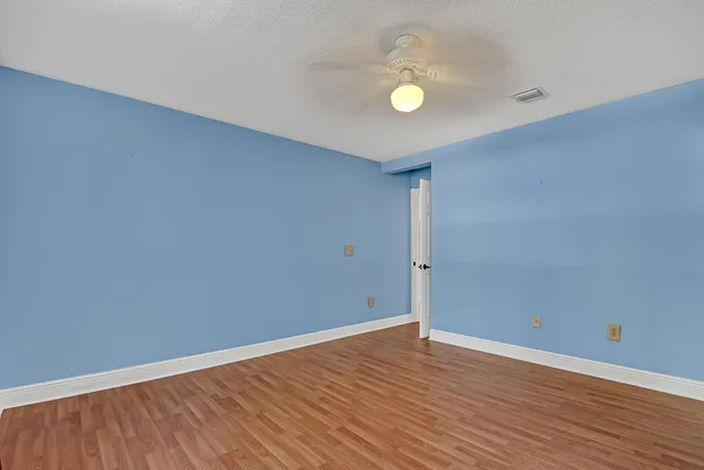 a view of an empty room and wooden floor