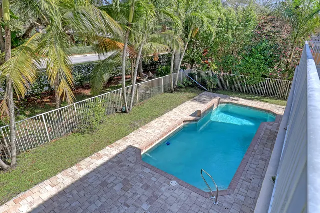 a view of a backyard with wooden fence