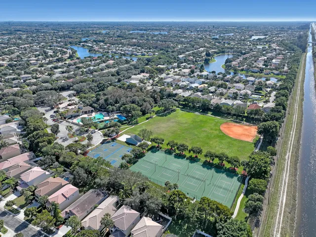 an aerial view of residential houses with outdoor space and trees