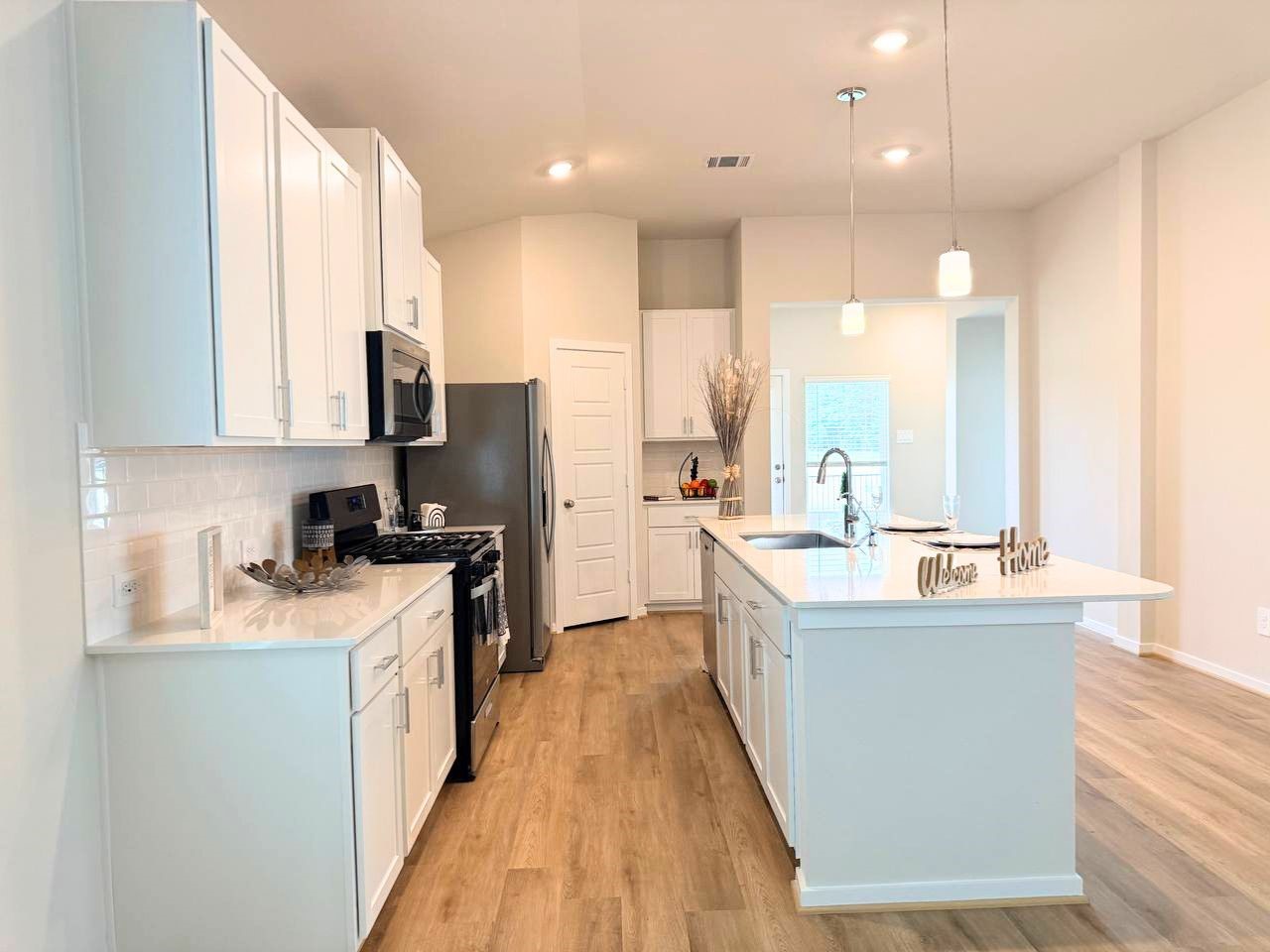 16246 Parish Pointe Court Conroe, TX 77302 - Photo 15 of 32 a kitchen with stainless steel appliances granite countertop a sink a stove and a refrigerator