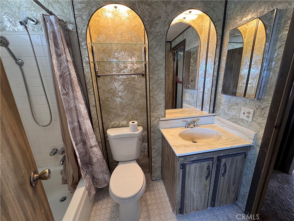 25544 Jasper Road Barstow, CA 92311 - Photo 27 of 62 a bathroom with a toilet sink and mirror