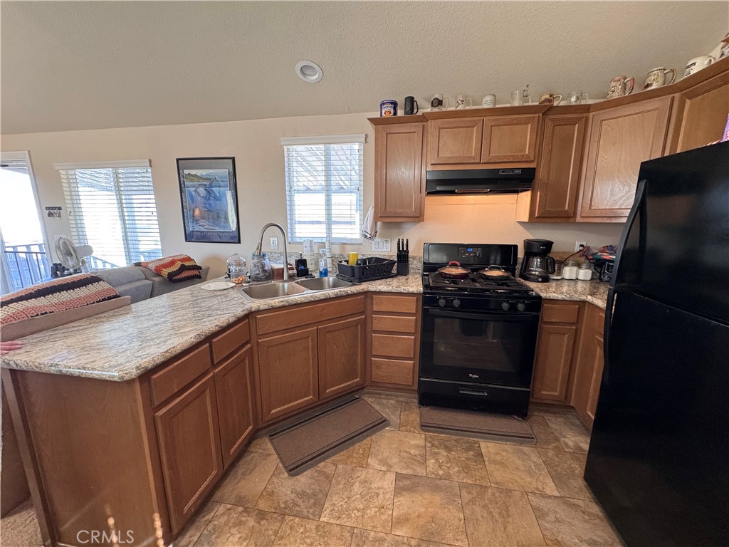 25544 Jasper Road Barstow, CA 92311 - Photo 39 of 62 a kitchen with a sink stove and refrigerator