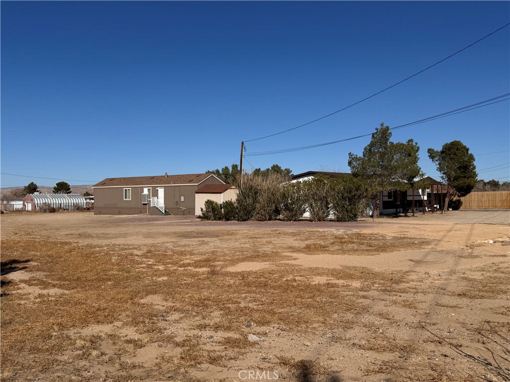 25544 Jasper Road Barstow, CA 92311 - Photo 55 of 62 a front view of a house with a yard