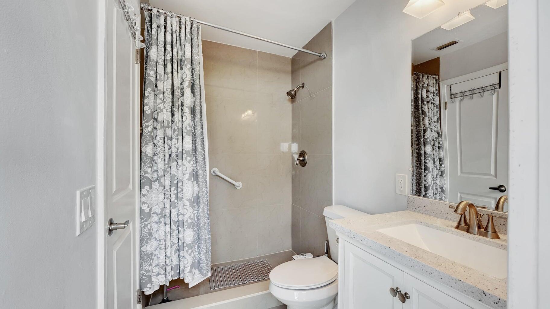 2941 Angler Drive Delray Beach, FL 33445 - Photo 12 of 34 a bathroom with a sink a toilet and shower