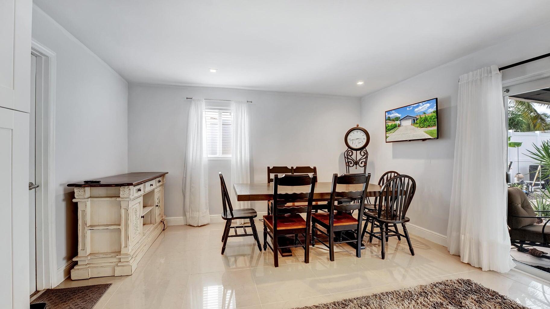 2941 Angler Drive Delray Beach, FL 33445 - Photo 13 of 34 a view of a dining room with furniture and wooden floor