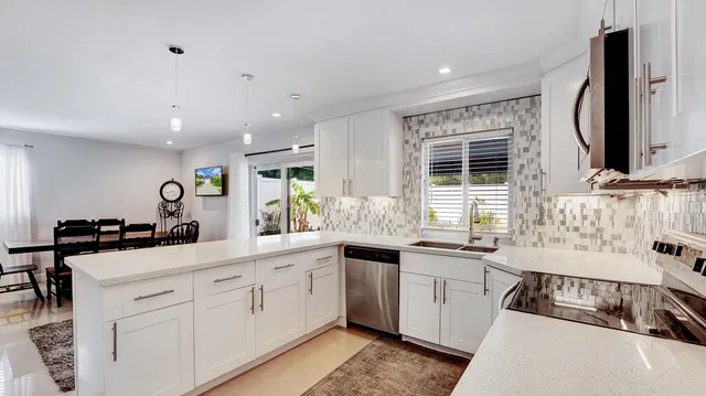 a kitchen with a sink stove and microwave