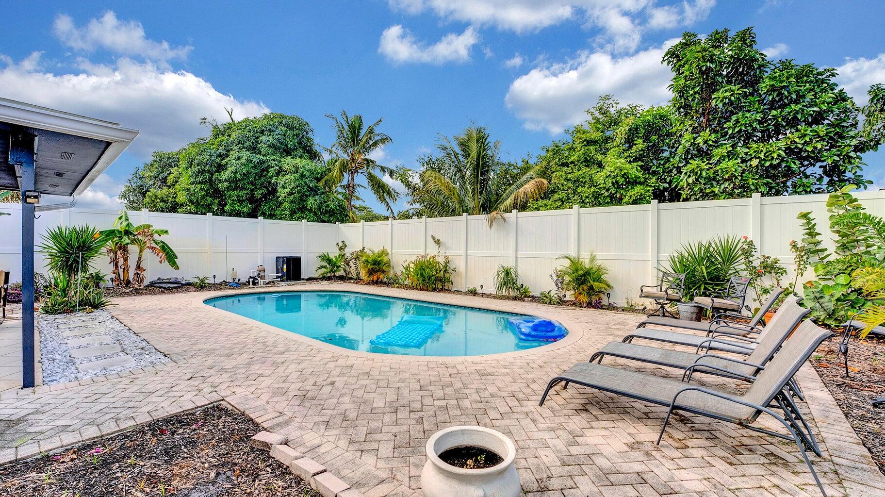 2941 Angler Drive Delray Beach, FL 33445 - Photo 20 of 34 a view of a swimming pool with chairs