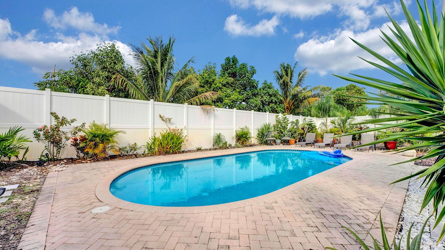 2941 Angler Drive Delray Beach, FL 33445 - Photo 21 of 34 a view of a swimming pool and lounge chair