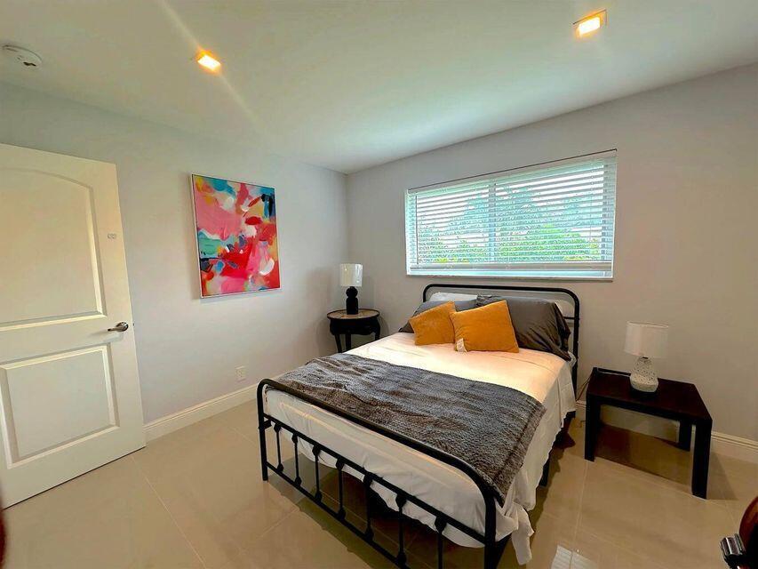 2941 Angler Drive Delray Beach, FL 33445 - Photo 28 of 34 a bedroom with a bed and dresser