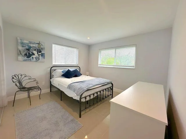 a bedroom with a bed and chair