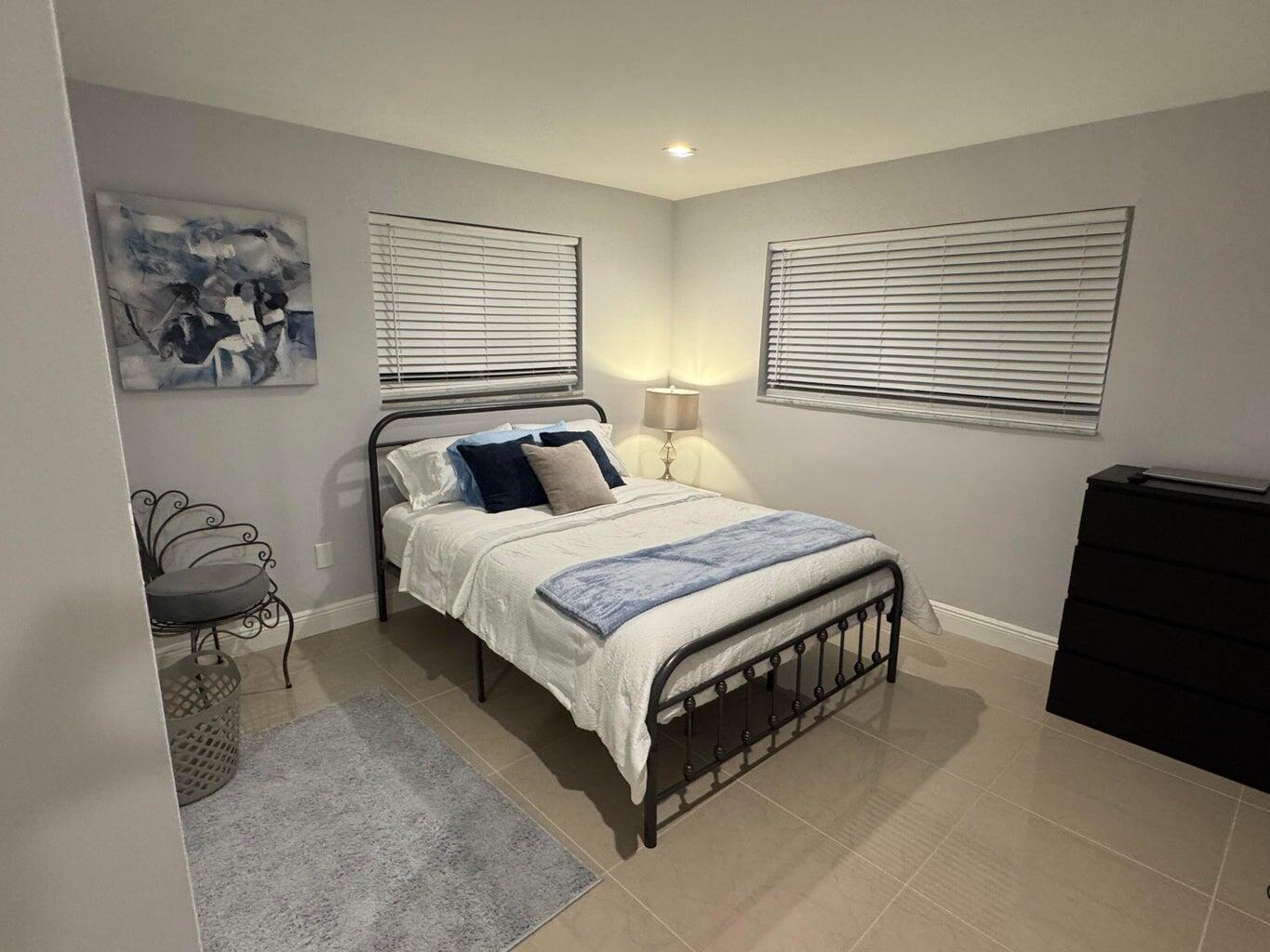 2941 Angler Drive Delray Beach, FL 33445 - Photo 31 of 34 a bedroom with a bed and chair