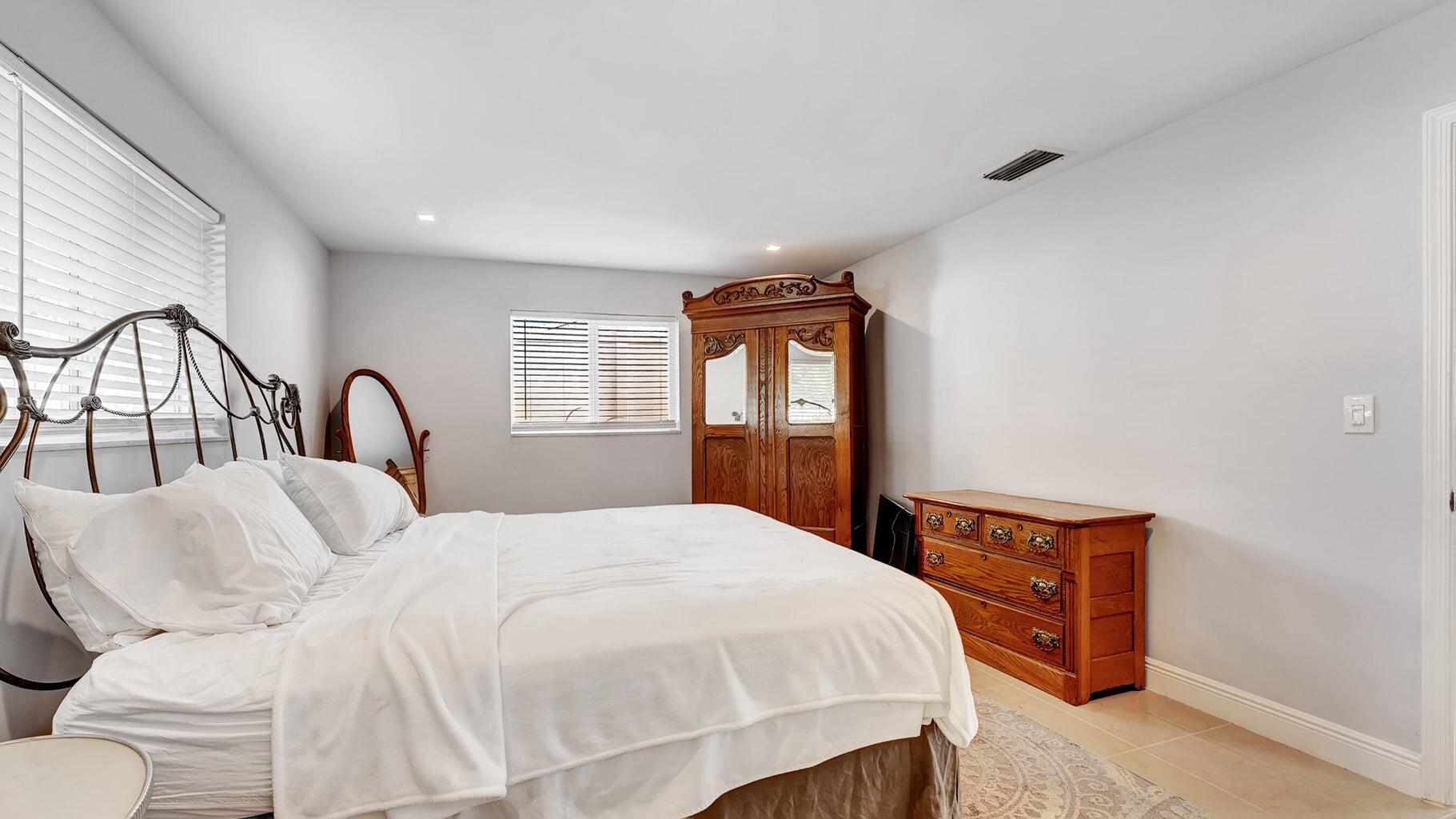 2941 Angler Drive Delray Beach, FL 33445 - Photo 10 of 34 a bedroom with a large bed and a window