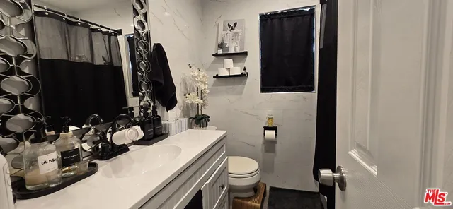 a kitchen with a stove and a flat screen tv