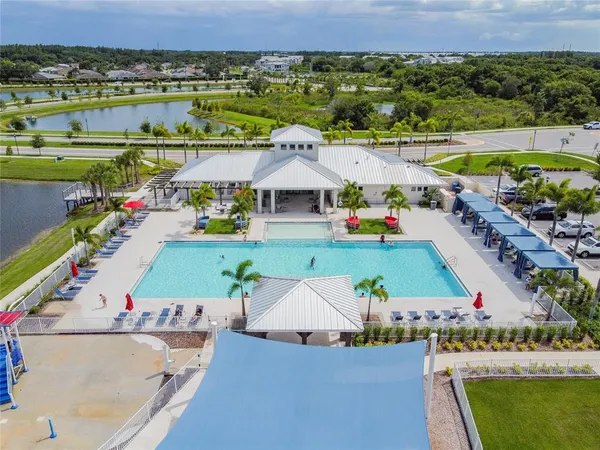 an aerial view of a house with a garden and lake view