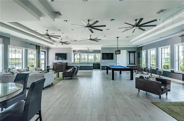 a living room with lots of furniture and a large window