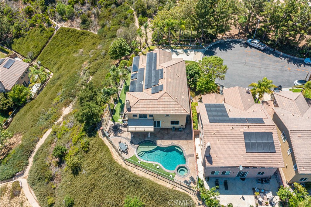 an aerial view of a house with a yard pool patio and outdoor seating