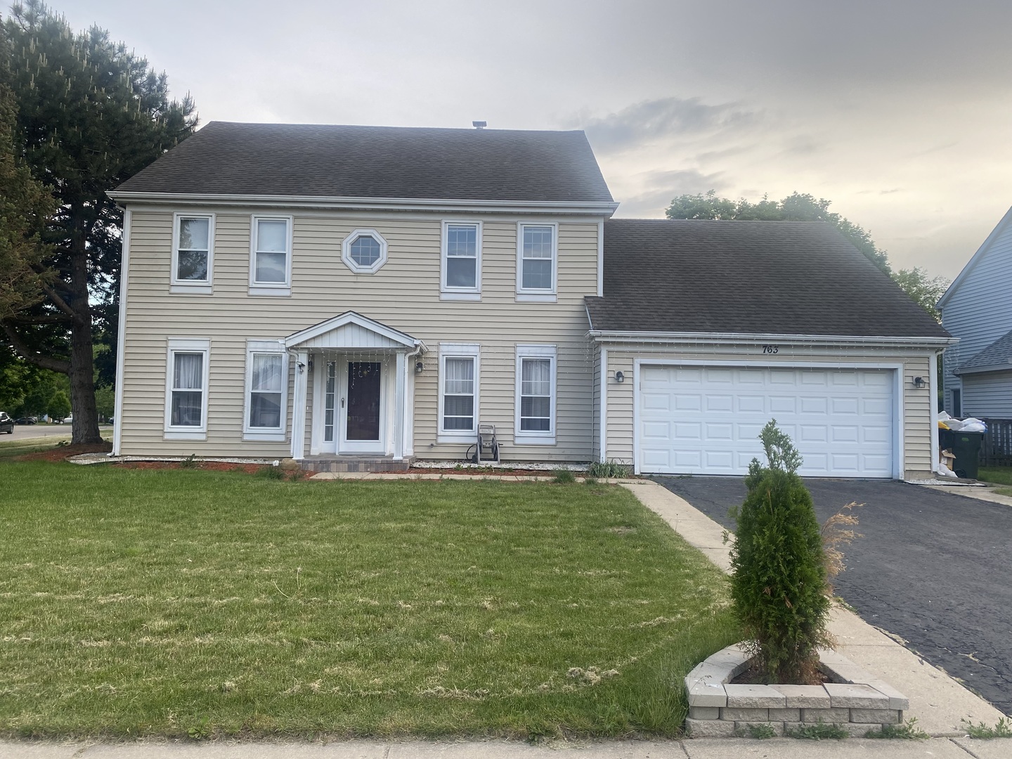 763 Cimarron Drive Cary, IL 60013 - Photo 1 of 15 a front view of a house with a garden