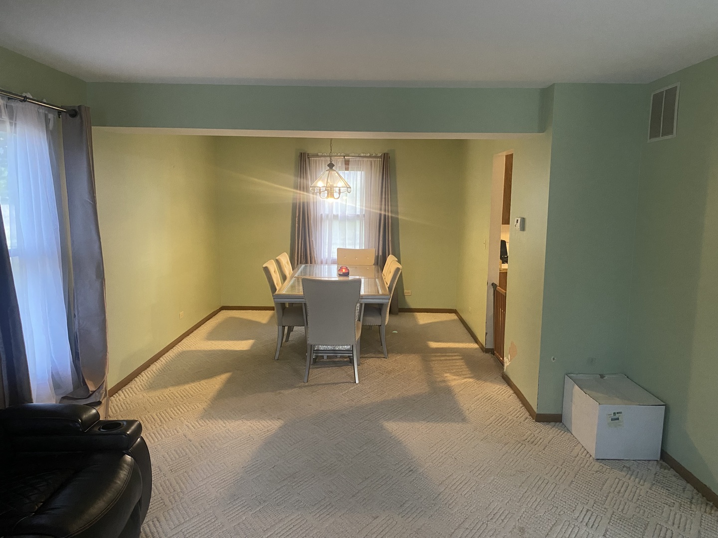763 Cimarron Drive Cary, IL 60013 - Photo 2 of 15 a dining room with furniture and a potted plant