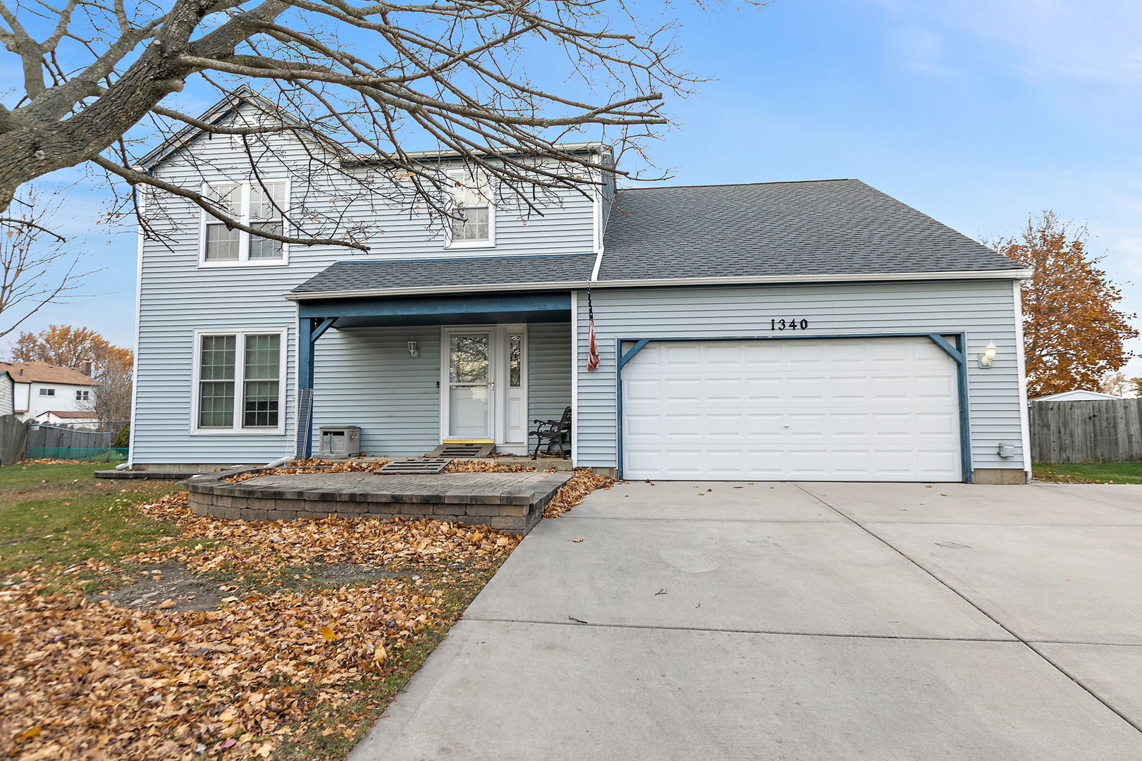 1340 Nantucket Court Carol Stream, IL 60188 - Photo 2 of 15 a front view of a house with a yard and garage