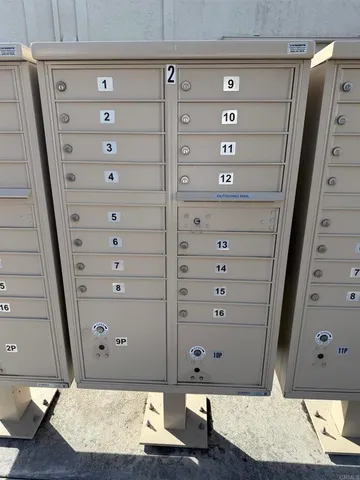 a front view of house with yard and trees in the background