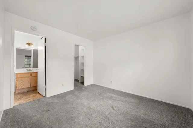 an empty room with kitchen and a sink