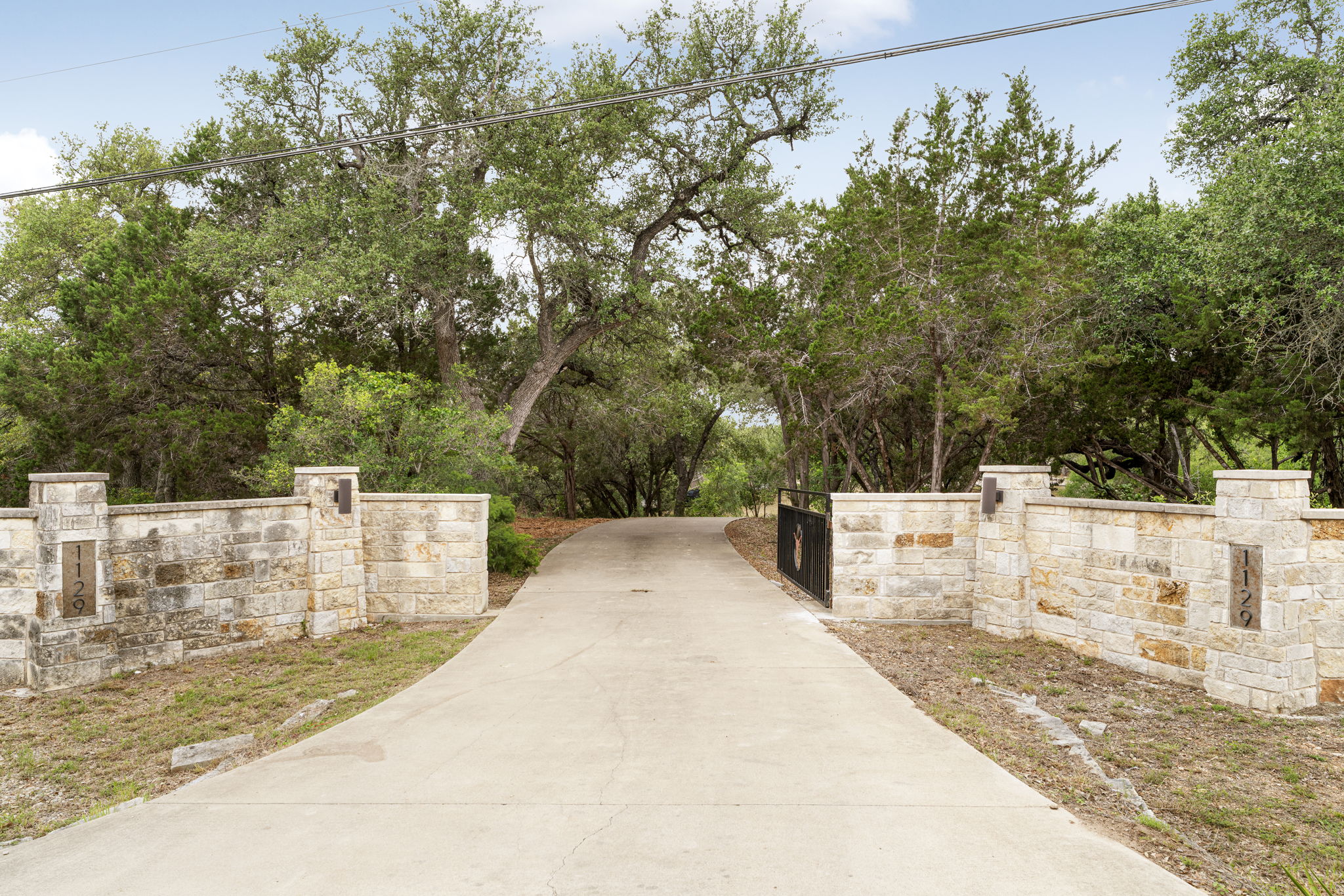 1129 Cedar Pass Road Driftwood, TX 78619 - Photo 36 of 40 Your arrival begins at these stately stone pillars and custom iron gates.