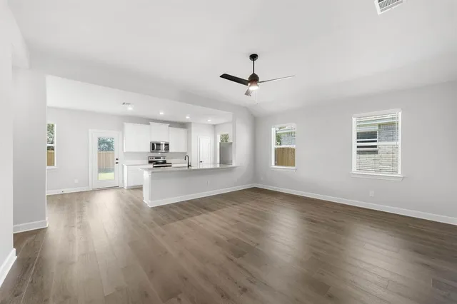 a view of kitchen with sink and wooden floor