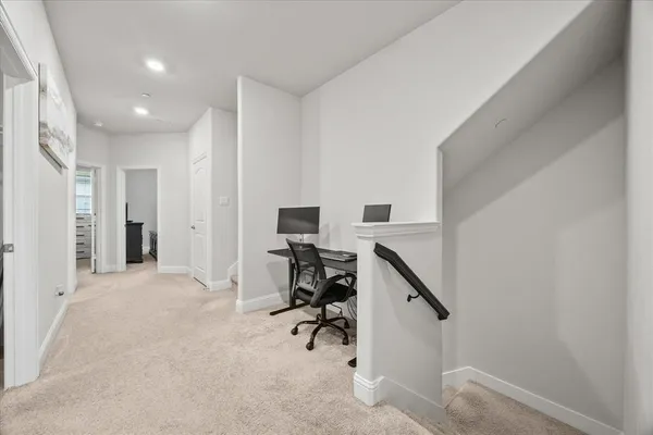 a view of workspace with furniture and staircase