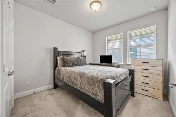 a bedroom with a bed and a dresser