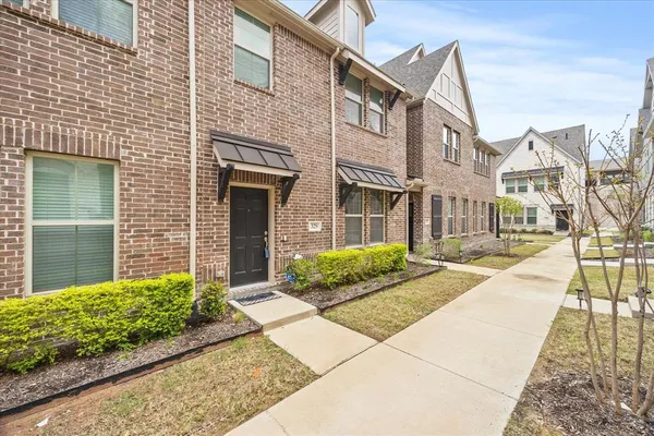 a view of a brick building next to a yard
