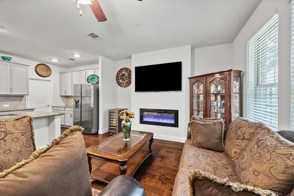 a living room with furniture a fireplace and a flat screen tv