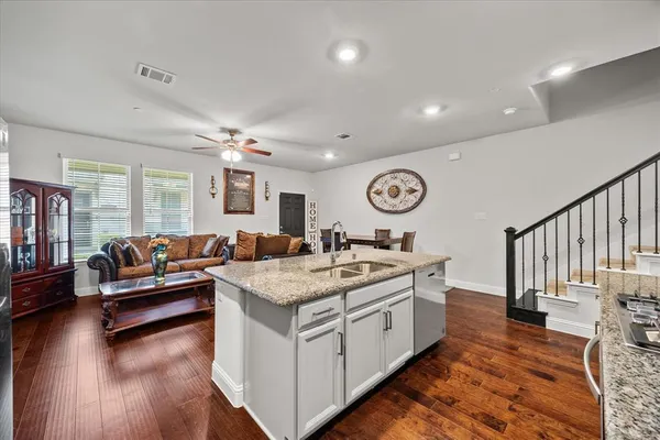 a view of living room with granite countertop furniture and a wooden floor