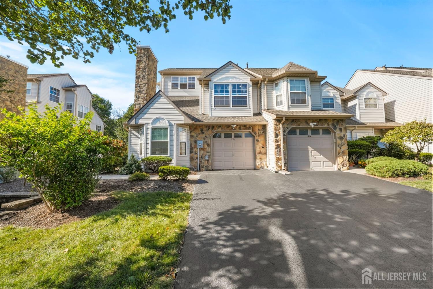 215 Nebula Road Piscataway, NJ 08854 - Photo 1 of 37 a front view of a house with a yard and garage